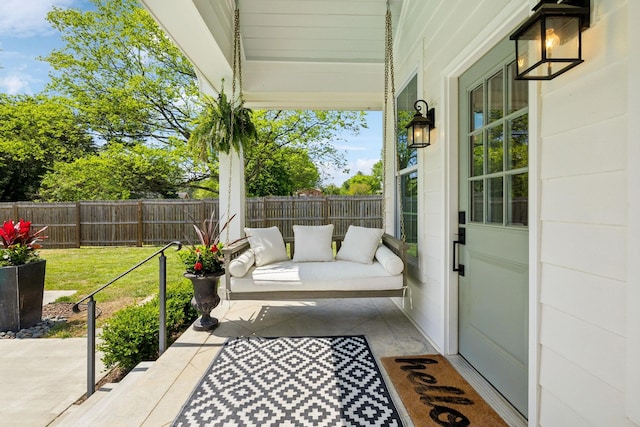 view of patio with a fenced backyard and a porch