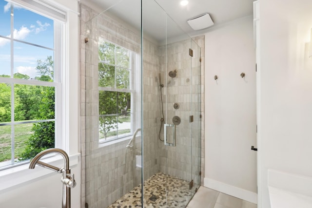 full bathroom featuring baseboards, tile patterned flooring, and a stall shower