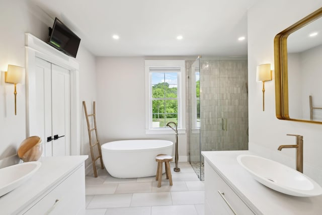 bathroom with vanity, recessed lighting, a freestanding tub, and a shower stall