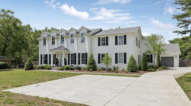 view of front facade with brick siding, an attached garage, driveway, and a front yard