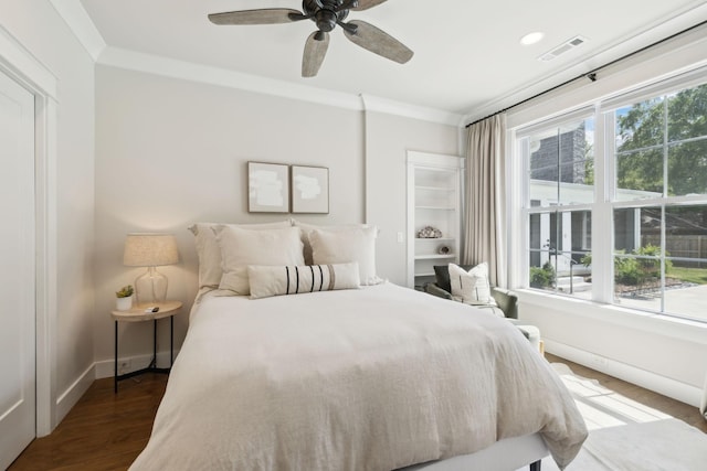 bedroom featuring baseboards, ceiling fan, wood finished floors, and visible vents