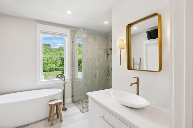bathroom featuring a freestanding bath, a shower stall, vanity, tile patterned floors, and recessed lighting