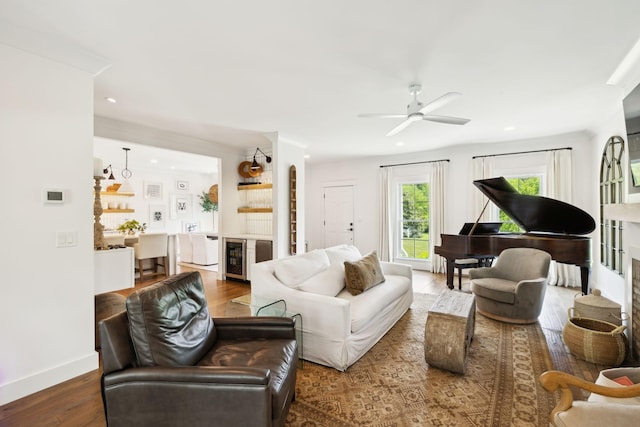 living area featuring baseboards, recessed lighting, ceiling fan, and wood finished floors