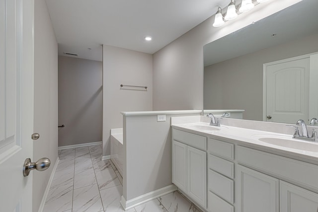 bathroom featuring a sink, baseboards, visible vents, and marble finish floor