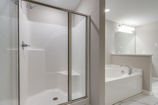 bathroom with a garden tub, marble finish floor, baseboards, and a stall shower