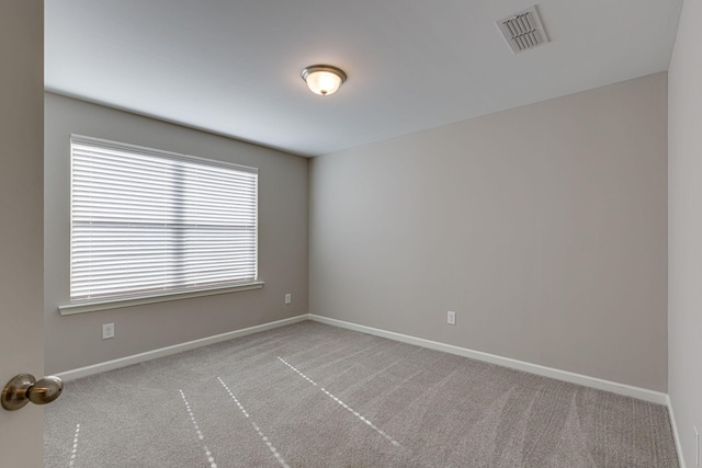 unfurnished room featuring baseboards, carpet, and visible vents