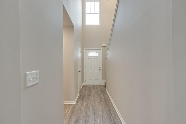 entryway with baseboards and light wood-type flooring