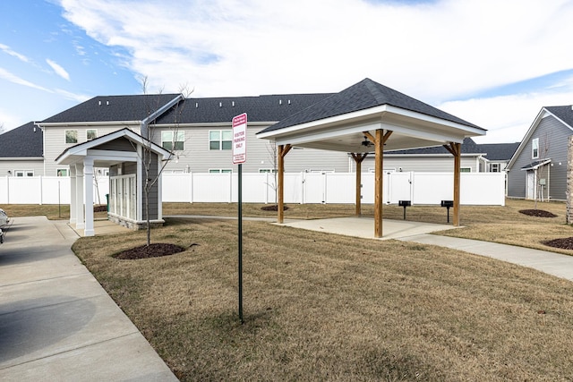view of home's community featuring a lawn, a gazebo, fence, and a patio area