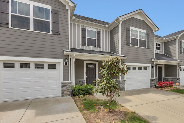 312 Mattie Ln, Spring Hill, TN 37174 - townhome / multi-family property featuring an attached garage, driveway, stone siding, a porch, and roof with shingles
