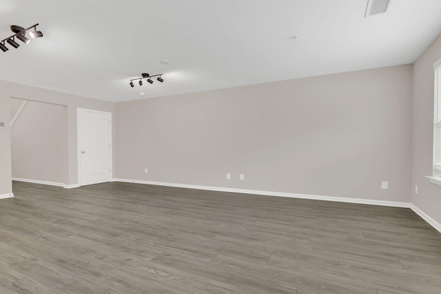 312 Mattie Ln, Spring Hill, TN 37174 - spare room featuring wood finished floors, baseboards, and rail lighting