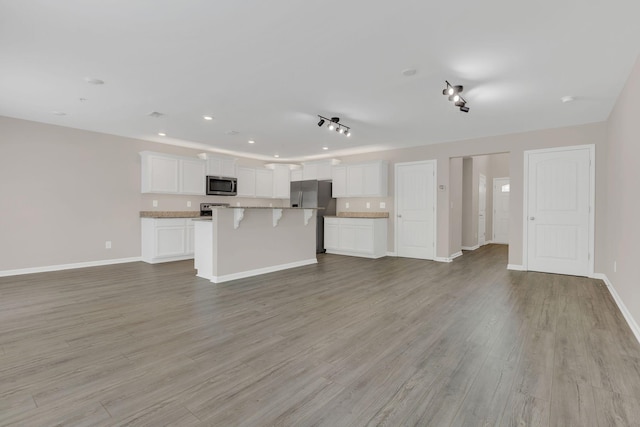 312 Mattie Ln, Spring Hill, TN 37174 - unfurnished living room featuring light wood-style floors, baseboards, and recessed lighting