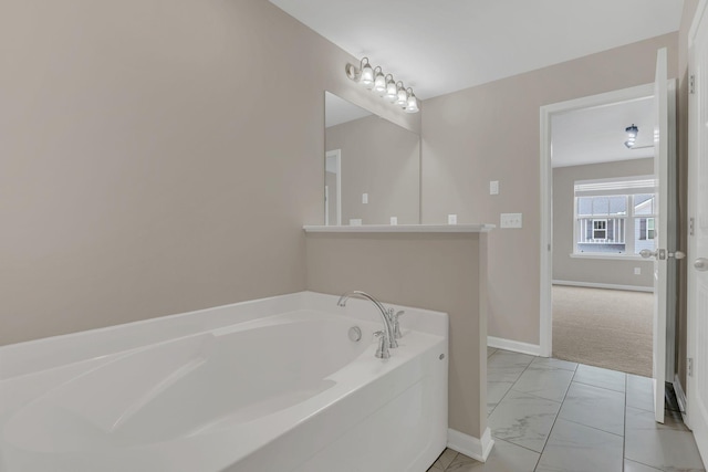 312 Mattie Ln, Spring Hill, TN 37174 - bathroom with marble finish floors, a bath, and baseboards