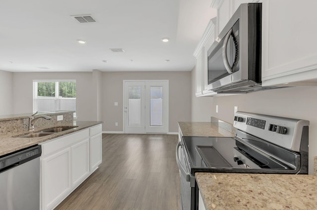 312 Mattie Ln, Spring Hill, TN 37174 - kitchen featuring appliances with stainless steel finishes, a sink, wood finished floors, white cabinetry, and light stone countertops
