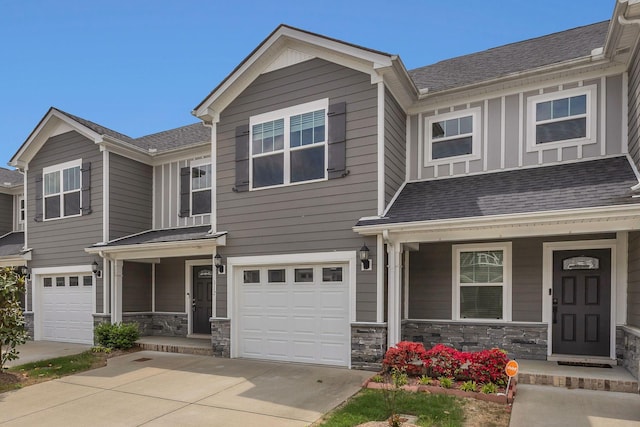 312 Mattie Ln, Spring Hill, TN 37174 - multi unit property featuring a porch, an attached garage, stone siding, and driveway