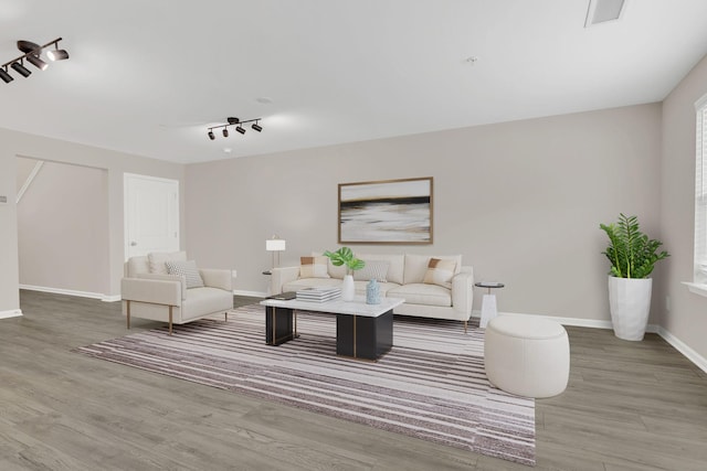 312 Mattie Ln, Spring Hill, TN 37174 - living room featuring wood finished floors, baseboards, and rail lighting