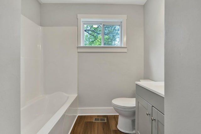 full bath with vanity, toilet, baseboards, wood finished floors, and visible vents
