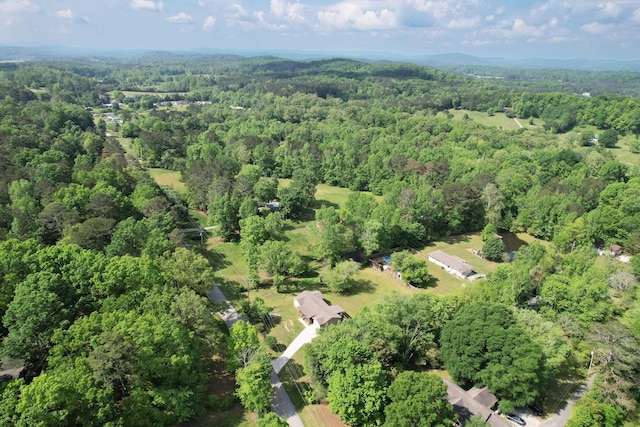 drone / aerial view featuring a forest view