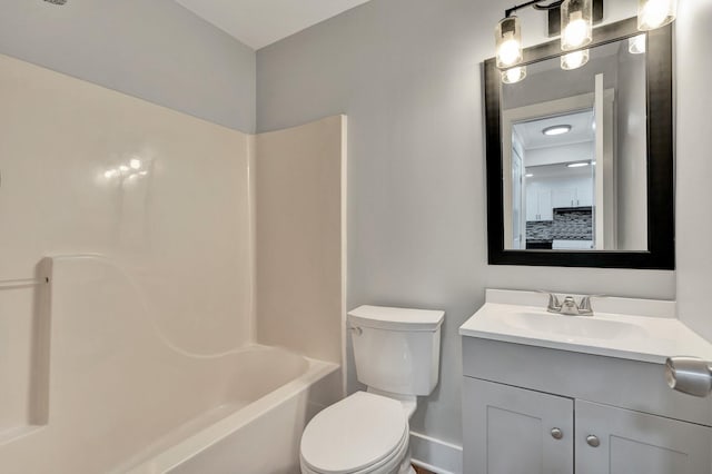 bathroom featuring vanity, baseboards, shower / bathtub combination, and toilet