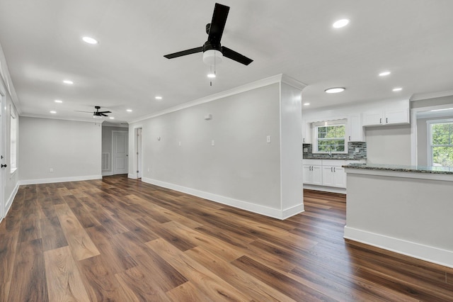 unfurnished living room featuring recessed lighting, a ceiling fan, baseboards, and crown molding