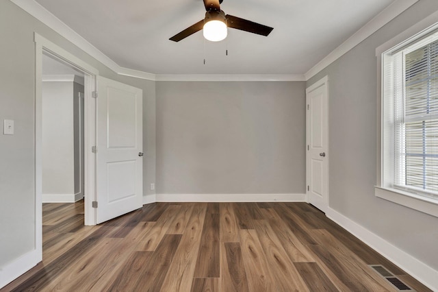 unfurnished room featuring visible vents, baseboards, ceiling fan, and wood finished floors