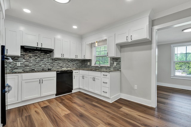 kitchen with dark wood-style flooring, black dishwasher, dark stone counters, white cabinets, and backsplash
