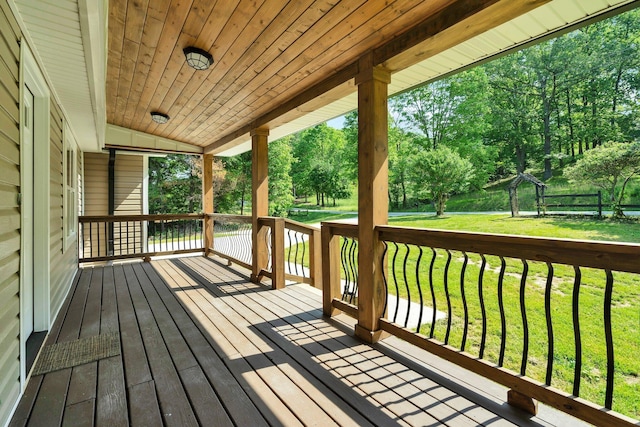 wooden terrace with a yard