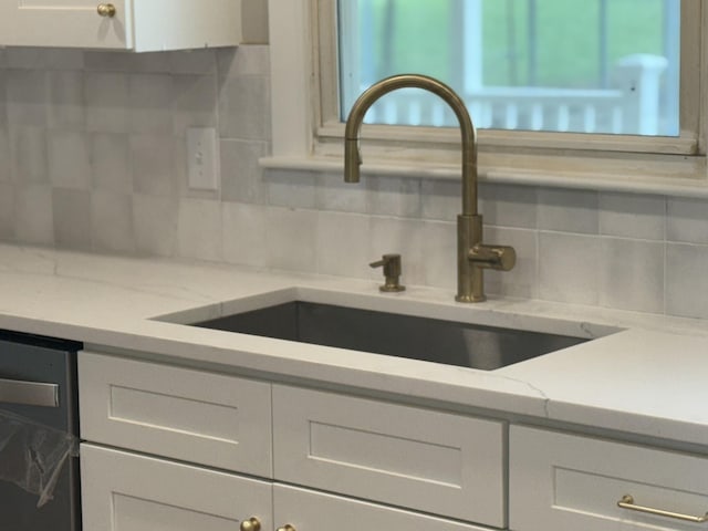 1025 Goshentown Rd, Hendersonville, TN 37075 - kitchen view of a sink, tasteful backsplash, and white cabinetry
