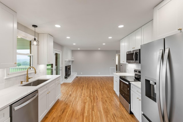 1025 Goshentown Rd, Hendersonville, TN 37075 - kitchen with stainless steel appliances, a sink, white cabinets, light countertops, and recessed lighting
