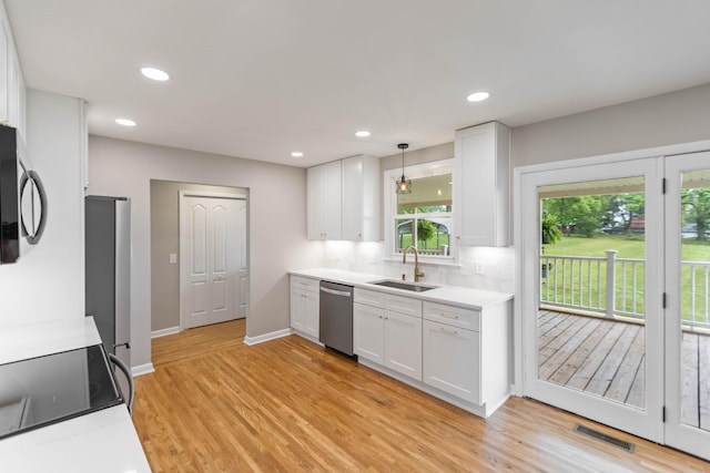 1025 Goshentown Rd, Hendersonville, TN 37075 - kitchen featuring a sink, stainless steel appliances, white cabinets, light countertops, and light wood-type flooring