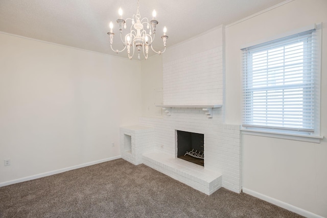 unfurnished living room featuring crown molding, a brick fireplace, carpet floors, baseboards, and a notable chandelier