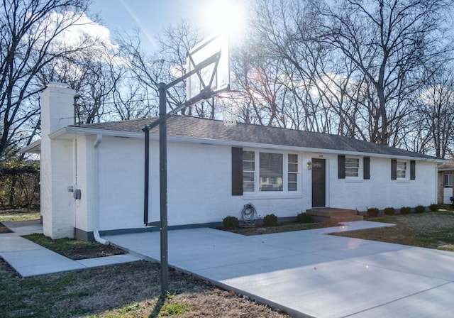 single story home featuring a chimney