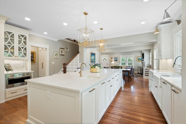 2004 Natchez Trce, Nashville, TN 37212 - kitchen featuring a sink, white cabinetry, stainless steel oven, and a notable chandelier