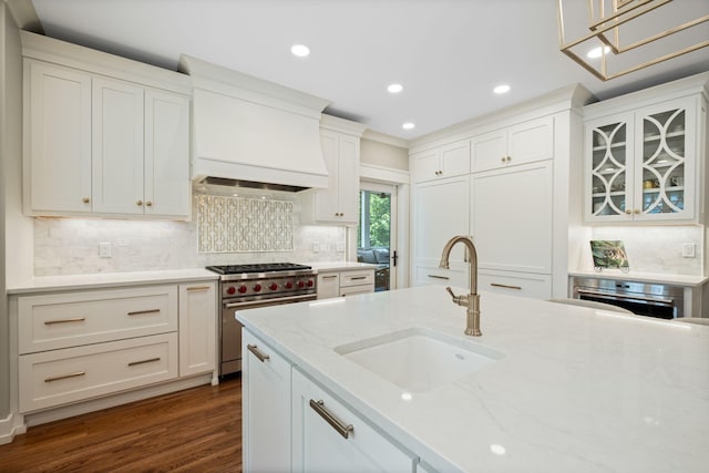 2004 Natchez Trce, Nashville, TN 37212 - kitchen featuring a sink, high end stove, custom range hood, backsplash, and dark wood-style floors