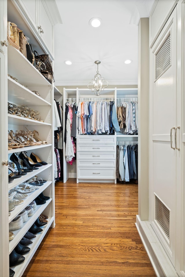 2004 Natchez Trce, Nashville, TN 37212 - walk in closet with visible vents, light wood-style flooring, and a notable chandelier