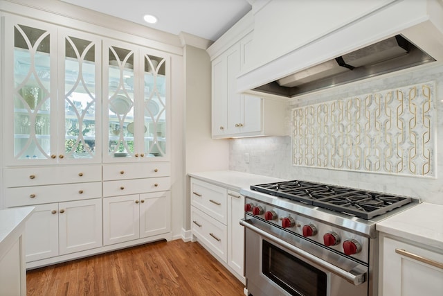 2004 Natchez Trce, Nashville, TN 37212 - kitchen featuring tasteful backsplash, high end range, light wood-style floors, custom range hood, and white cabinetry