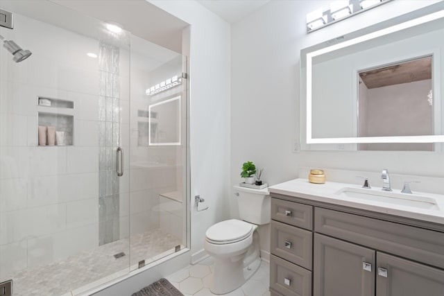 1510 Demonbreun St Unit 807, Nashville, TN 37203 - bathroom featuring vanity, a stall shower, tile patterned floors, and toilet