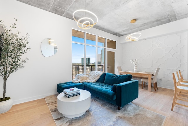 1510 Demonbreun St Unit 807, Nashville, TN 37203 - living room featuring baseboards, a chandelier, and wood finished floors