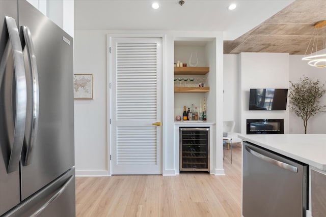 1510 Demonbreun St Unit 807, Nashville, TN 37203 - kitchen featuring wine cooler, light wood-style floors, recessed lighting, light countertops, and stainless steel appliances