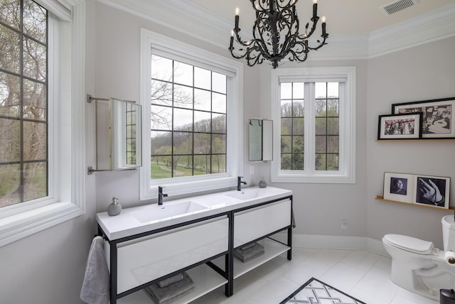 bathroom featuring visible vents, a sink, crown molding, and toilet