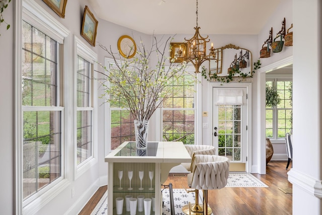 sunroom with a notable chandelier and a healthy amount of sunlight