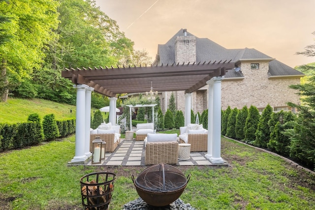 view of yard with an outdoor living space with a fire pit, a pergola, and a patio