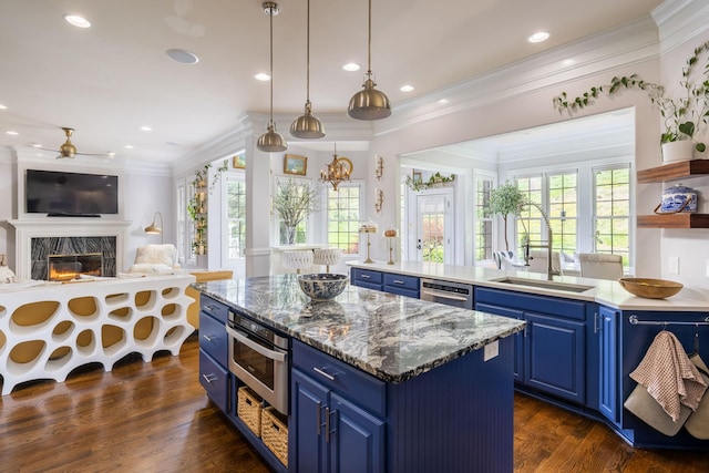 kitchen featuring stainless steel appliances, open shelves, a sink, and blue cabinets