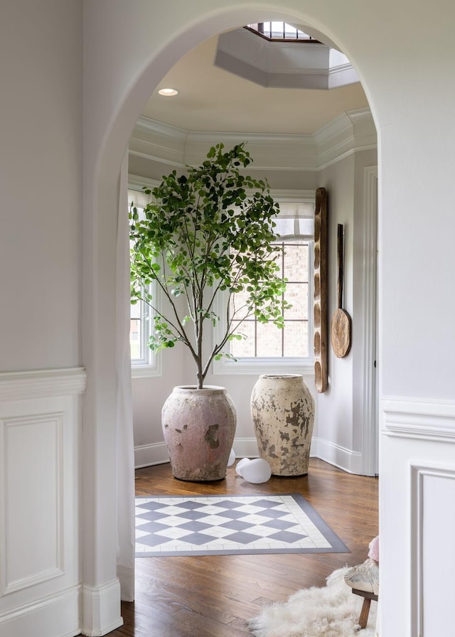 interior details featuring crown molding, baseboards, and wood finished floors