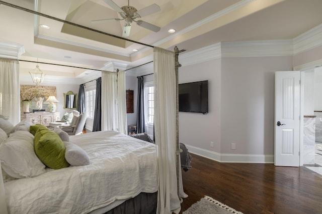 bedroom featuring crown molding, wood finished floors, baseboards, recessed lighting, and a tray ceiling