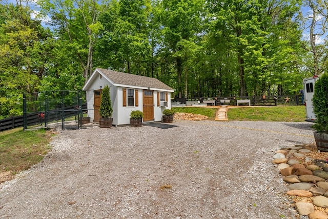 6498 Arno College Grove Rd, College Grove, TN 37046 - exterior space featuring fence, roof with shingles, a gate, an outbuilding, and driveway