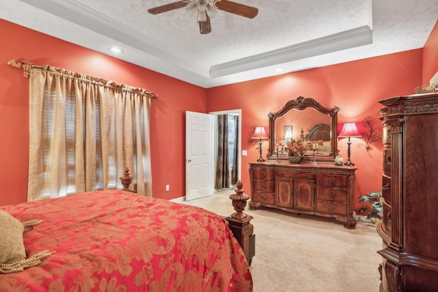 carpeted bedroom featuring crown molding, recessed lighting, a textured ceiling, a raised ceiling, and a ceiling fan