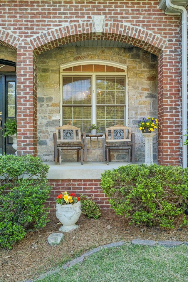 doorway to property with brick siding and stone siding