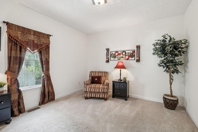 living area with baseboards, carpet, and visible vents