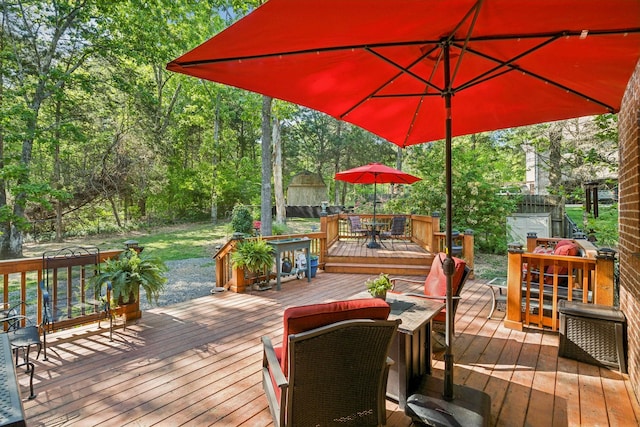 wooden terrace featuring outdoor dining area