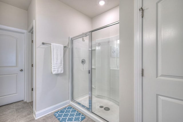 bathroom featuring recessed lighting, baseboards, tile patterned flooring, and a stall shower